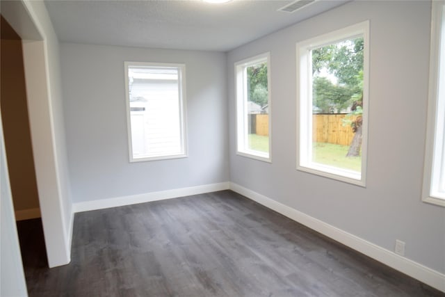 unfurnished room featuring dark wood-type flooring