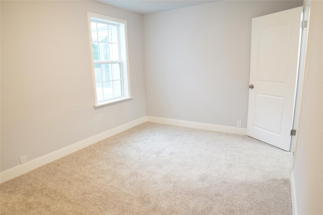 empty room featuring light carpet