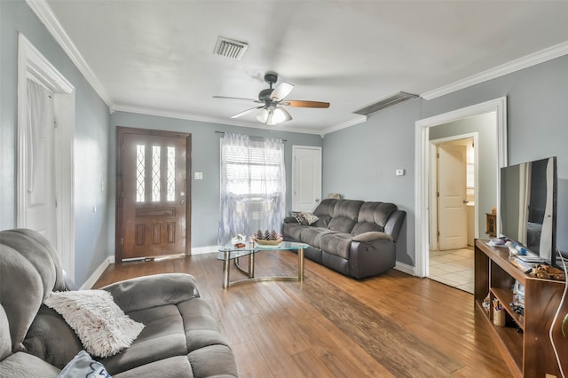 living room with crown molding, ceiling fan, and wood-type flooring