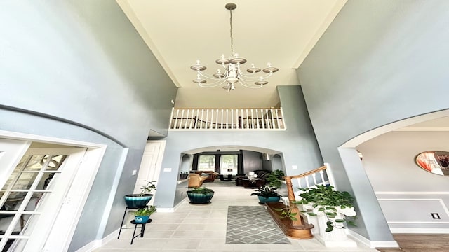 interior space featuring an inviting chandelier and a high ceiling