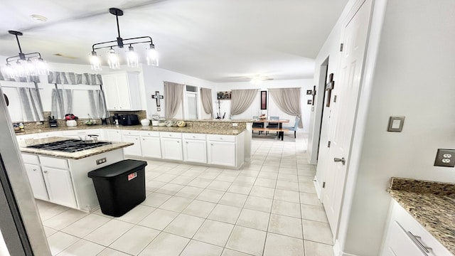 kitchen featuring pendant lighting, white cabinetry, stainless steel gas cooktop, and a center island