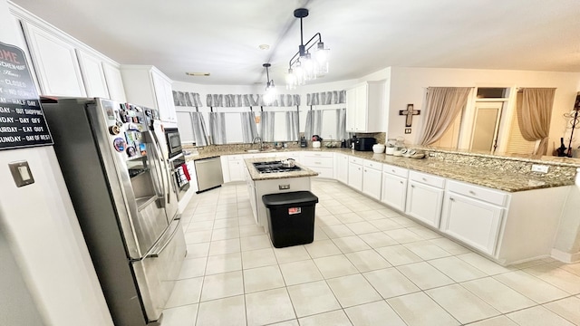 kitchen featuring appliances with stainless steel finishes, white cabinetry, and a kitchen island