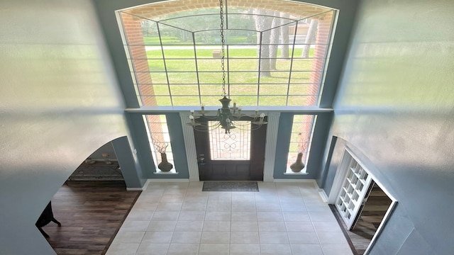 entrance foyer with a notable chandelier, hardwood / wood-style floors, and a wealth of natural light