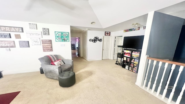 sitting room with vaulted ceiling and light colored carpet