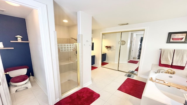 bathroom with tile patterned flooring, independent shower and bath, and vanity