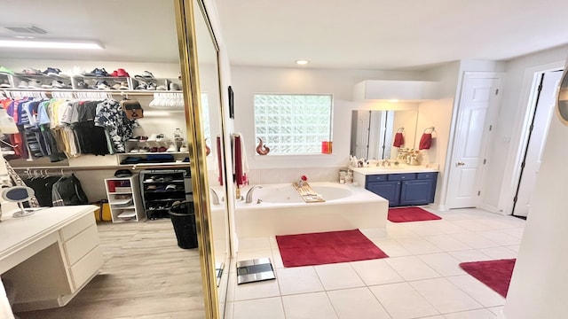 bathroom featuring a bathtub, tile patterned flooring, and vanity