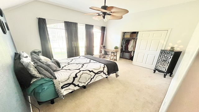 bedroom featuring ceiling fan, light colored carpet, a closet, and lofted ceiling