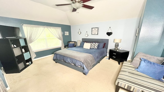 bedroom with lofted ceiling, ceiling fan, and light colored carpet