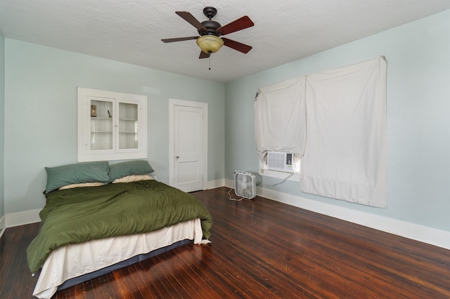 bedroom featuring ceiling fan, hardwood / wood-style flooring, a textured ceiling, and cooling unit