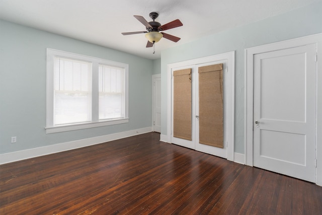 unfurnished bedroom featuring ceiling fan, french doors, two closets, and hardwood / wood-style floors