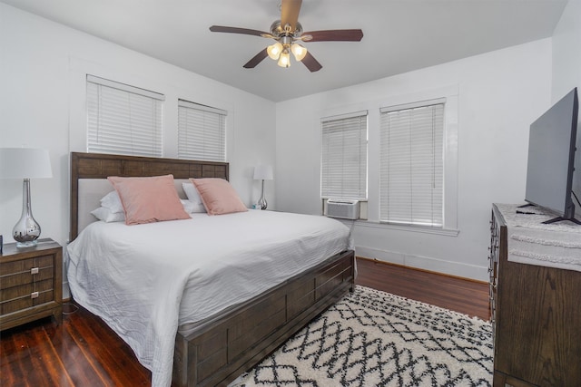 bedroom featuring ceiling fan, dark wood-type flooring, and cooling unit