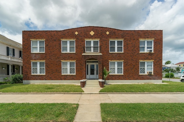 view of front facade featuring a front lawn and a balcony