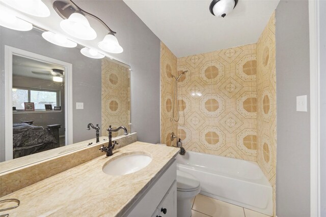 full bathroom with toilet, tile patterned floors, vanity, and tiled shower / bath