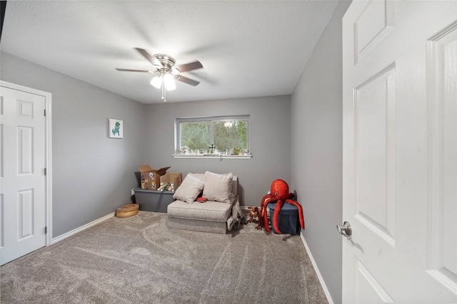 sitting room with ceiling fan and carpet floors