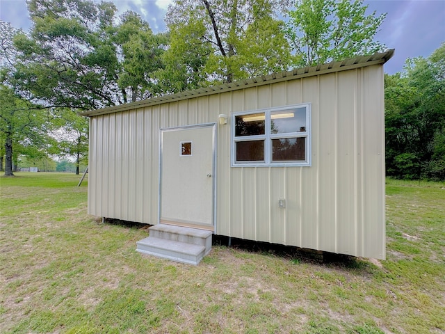 view of outdoor structure featuring a lawn