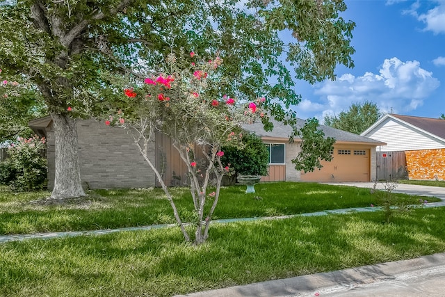 view of front of property with a front lawn and a garage