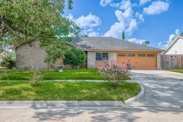 single story home with a front yard and a garage