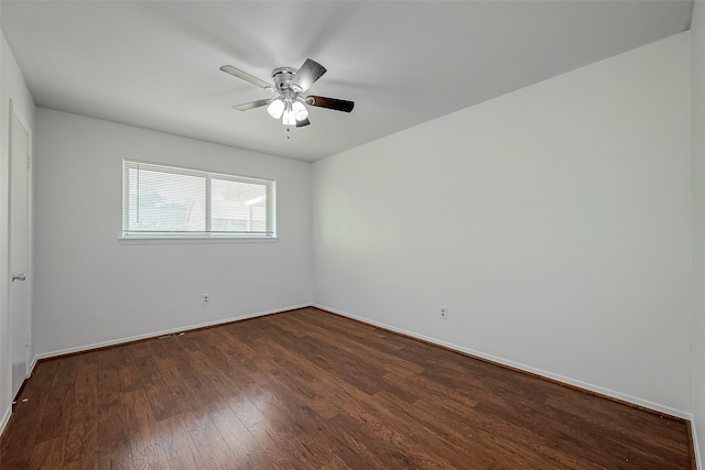 empty room with ceiling fan and dark hardwood / wood-style flooring