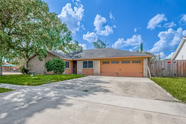 ranch-style home featuring a garage and a front yard