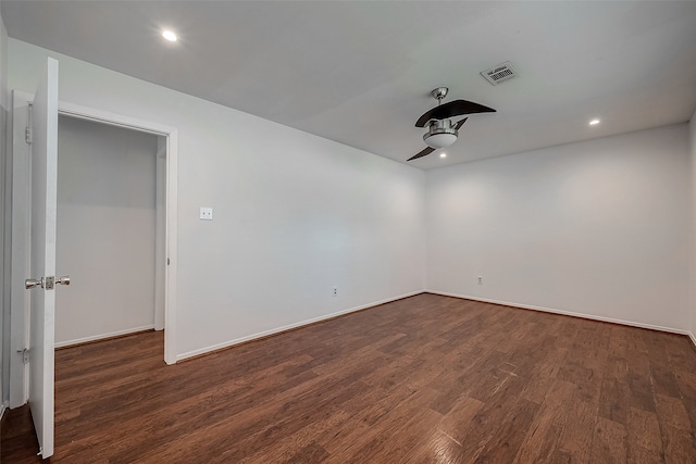 empty room with dark wood-type flooring and ceiling fan