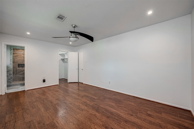 empty room with ceiling fan and dark hardwood / wood-style flooring