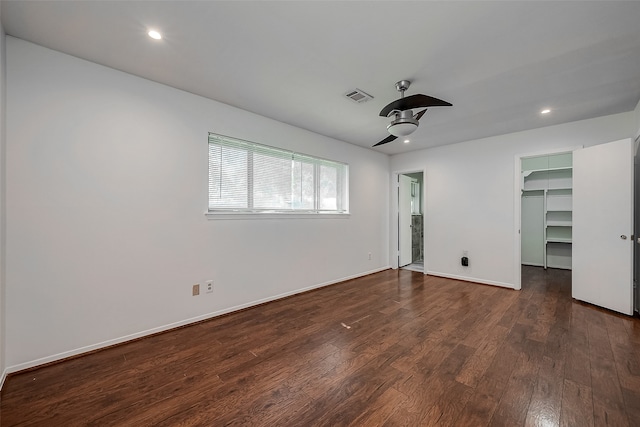 empty room with dark wood-type flooring and ceiling fan