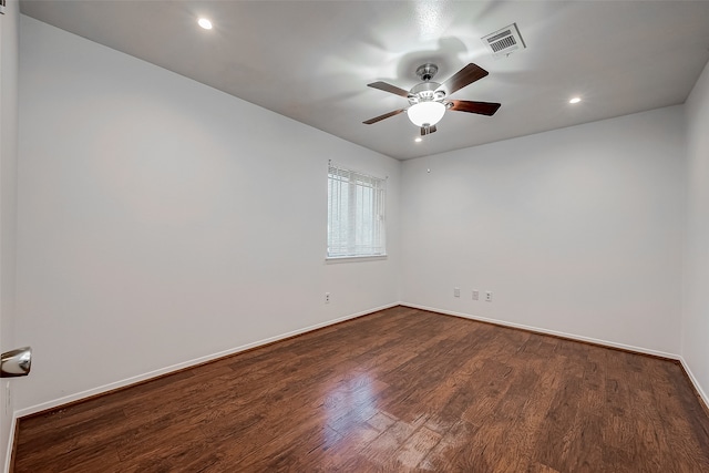 spare room featuring ceiling fan and dark hardwood / wood-style flooring