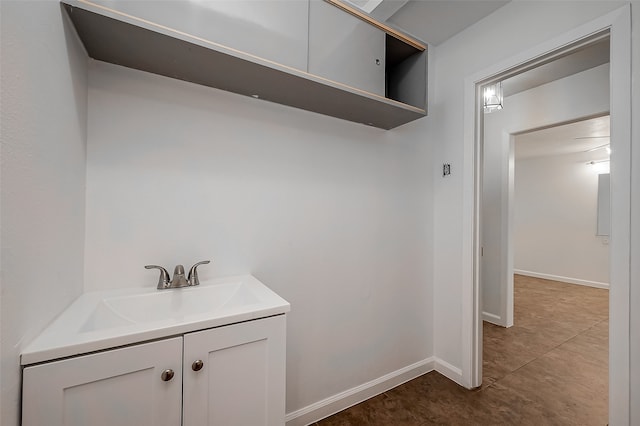 interior space with sink and dark tile patterned floors