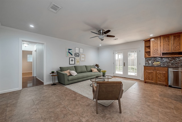 living room with tile patterned flooring, ceiling fan, and ornamental molding