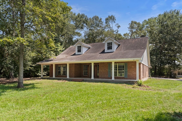 cape cod home with a front yard