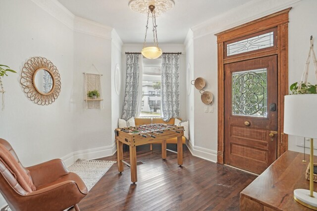 foyer featuring ornamental molding and dark wood-type flooring