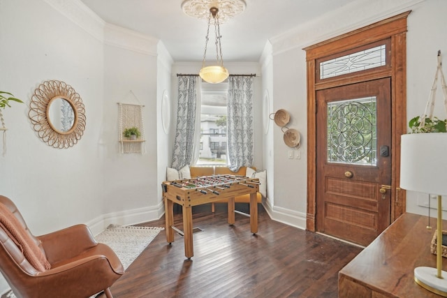 entryway featuring ornamental molding, dark wood finished floors, and baseboards