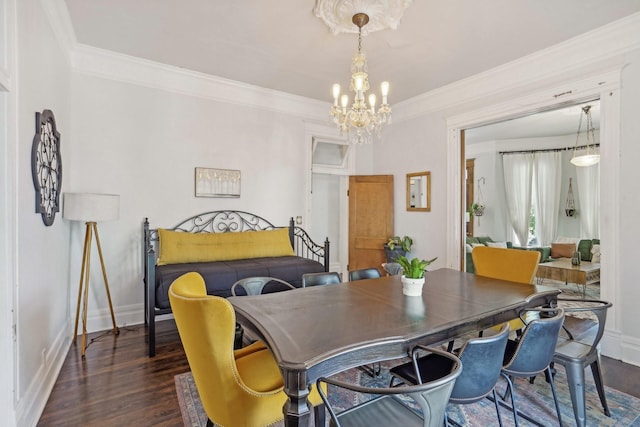 dining space featuring crown molding, a notable chandelier, dark wood finished floors, and baseboards