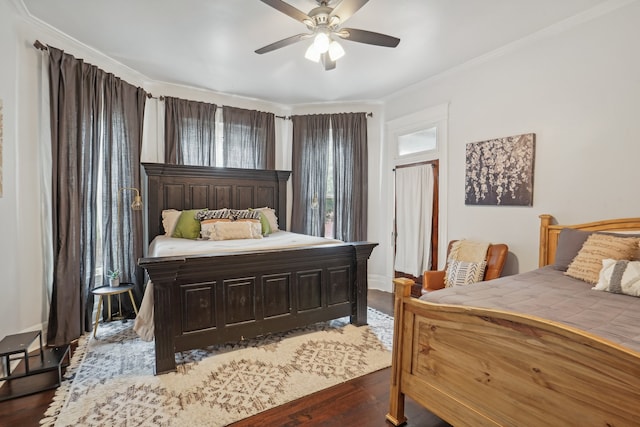 bedroom with hardwood / wood-style floors, ornamental molding, multiple windows, and ceiling fan