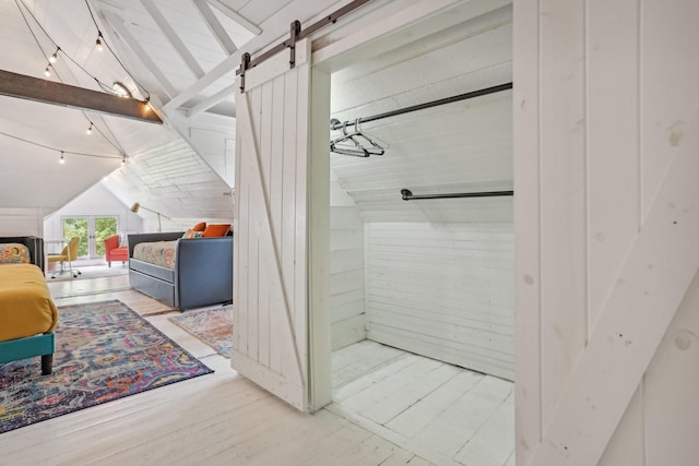 bathroom featuring lofted ceiling with beams, track lighting, wood finished floors, and wooden walls