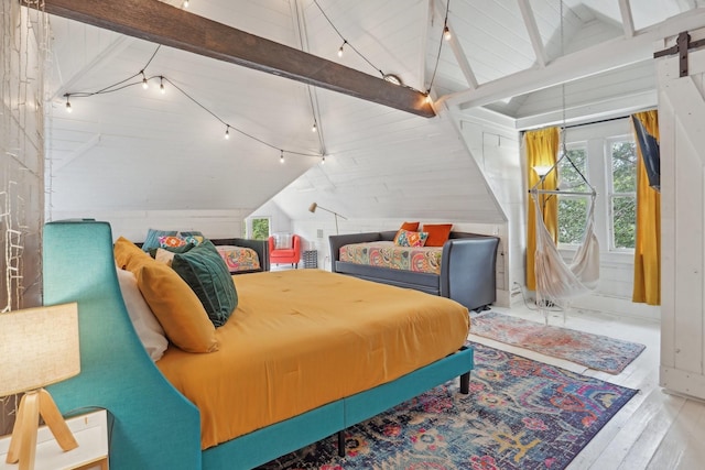 bedroom with rail lighting, vaulted ceiling with beams, and wood finished floors