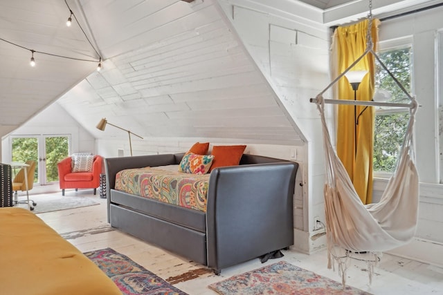 bedroom with vaulted ceiling, hardwood / wood-style flooring, and track lighting