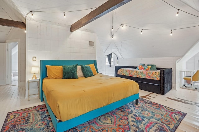 bedroom with vaulted ceiling with beams, track lighting, visible vents, and wood finished floors