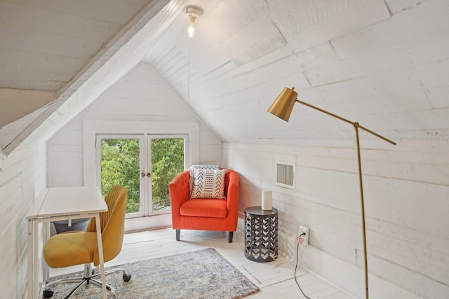 office space featuring lofted ceiling, wood finished floors, and visible vents