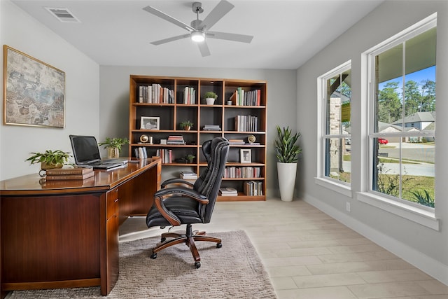 office featuring ceiling fan, light hardwood / wood-style flooring, and a healthy amount of sunlight