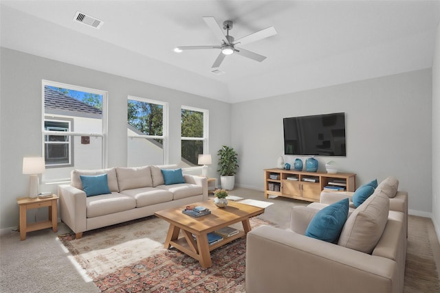 living room with ceiling fan, vaulted ceiling, and carpet flooring