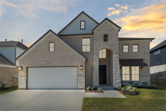 view of front of property featuring a garage and a yard