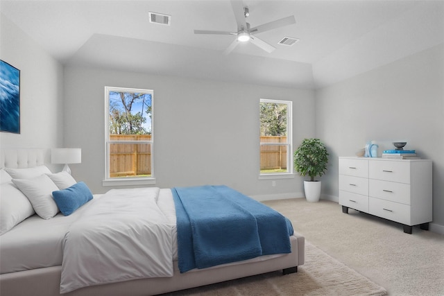 bedroom with ceiling fan, light colored carpet, and lofted ceiling