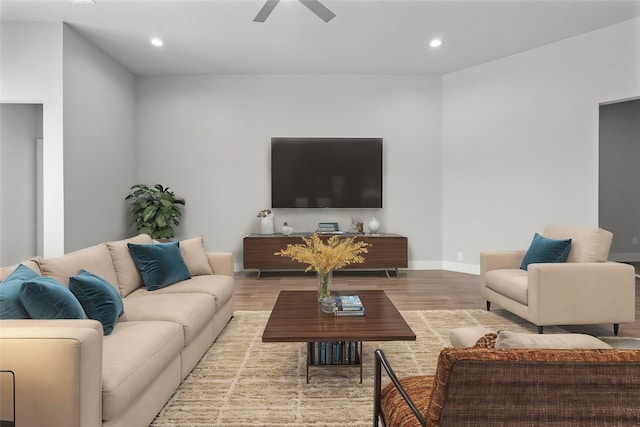 living room featuring ceiling fan and light hardwood / wood-style floors