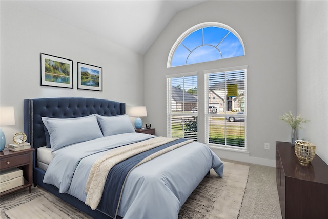 bedroom with light carpet and lofted ceiling