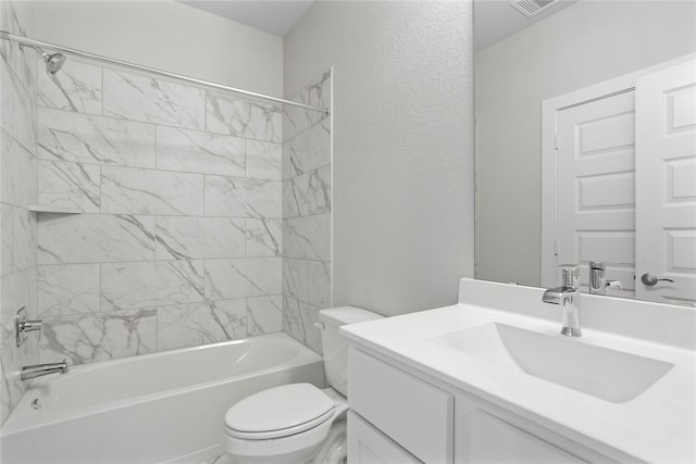 full bathroom featuring toilet, vanity, and tiled shower / bath