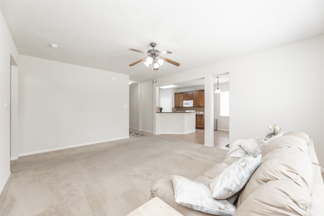 carpeted living room featuring ceiling fan