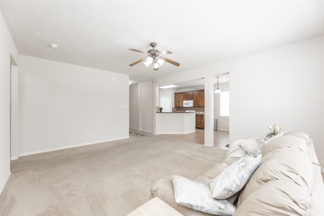 living room with ceiling fan and light colored carpet