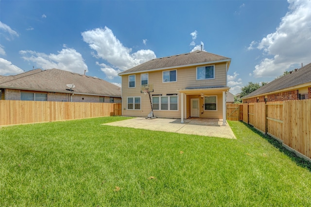 rear view of house with a lawn and a patio area