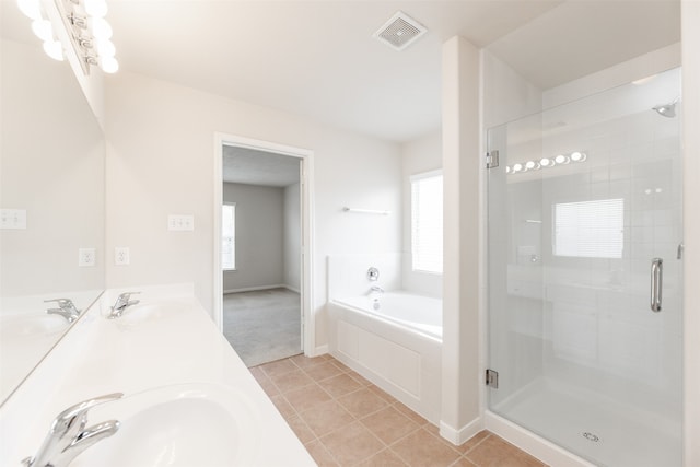 bathroom featuring dual vanity, a wealth of natural light, tile patterned flooring, and separate shower and tub